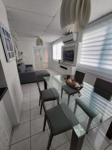 a living room with a glass table and chairs at MF Vacation Homes Villa 2 in Loiza