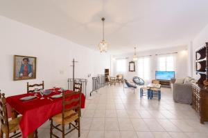 a living room and dining room with a table and chairs at Rethymno Heart Apartment in Áyios Andónios