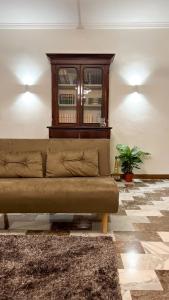 a living room with a couch and a window at Gelsi Apartment - Roma Metro C in Rome