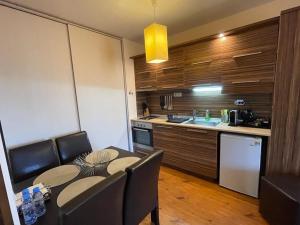 uma cozinha com mesa e cadeiras e uma cozinha com balcão em Lorena’s Apartment Bansko,near Gondola em Bansko