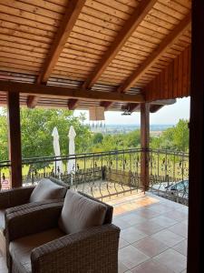 a screened in porch with a couch and a balcony at Kuća za odmor Mirna in Cepidlak