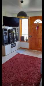 a living room with a red rug on the floor at CABAÑAS LOMAS DE YECO in Valdivia