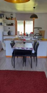 a kitchen with a table and chairs in a room at CABAÑAS LOMAS DE YECO in Valdivia