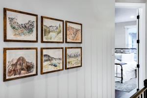 a group of framed drawings on a wall at Evergreen - A Birdy Vacation Rental in San Antonio