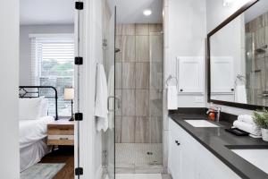 a bathroom with a shower and a sink and a mirror at Evergreen - A Birdy Vacation Rental in San Antonio