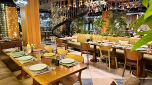 a dining room with tables and chairs and a chandelier at Ribas Karpaty in Bukovel