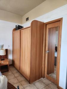 um quarto com um armário de madeira e uma porta em Tropical Executive Hotel em Manaus