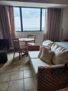 a living room with a couch and a table at Tropical Executive Hotel in Manaus