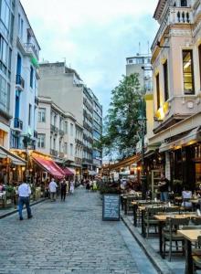 a city street with tables and chairs and buildings at Ladadika Luxury Apartment #4 in Thessaloniki