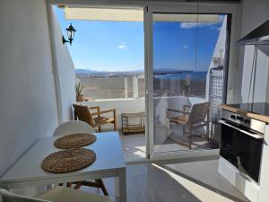 a living room with a view of the ocean at Apartamentos Cotillo Family in El Cotillo