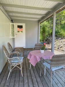 a patio with a table and chairs on a deck at Bergliot Bed & Breakfast in Hundested