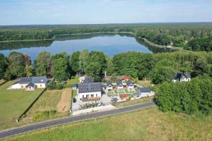 una vista aerea di una grande casa con lago di Dębówka a Wilcze