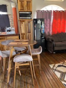 a kitchen with a table and some chairs and a couch at Elite's Ocean View in Montego Bay