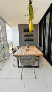 a dining room with a wooden table and chairs at Newton’s Place - Luxury styled 2 BD Apartment in Midrand
