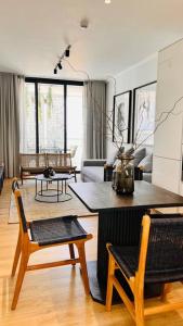 a living room with a table and chairs at Newton’s Place - Luxury styled 2 BD Apartment in Midrand