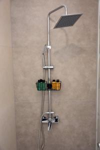 a shower with a shower head in a bathroom at Olgas cozy home in Chania