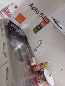 a kitchen with a sink and a counter top at Jardim Santa Rosália in Sorocaba