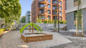 an empty playground in a park in front of a building at Tobiase Residences - Luxury Apartments in Tallinn