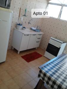 a kitchen with a stove and a sink in it at Jardim Santa Rosália in Sorocaba