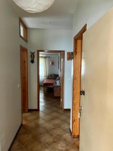 a hallway with a door open to a living room at Splendid Guest Suite with Separate Private Ocean View Terrace in Praia