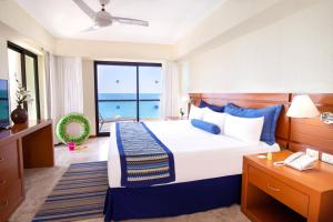 a bedroom with a bed with a view of the ocean at Plaza Pelicanos Grand Beach Resort All Inclusive in Puerto Vallarta +124 photos