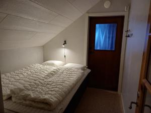 Cama blanca en habitación con ventana en Kiruna accommodation Gustaf Wikmansgatan 6b villa 8 pers, en Kiruna