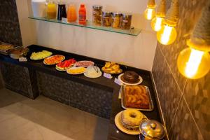 a buffet with many different types of pastries and desserts at Hotel Pousada Figueiredo in Araruama