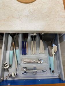 a drawer filled with utensils sitting under a counter at ΚΑΛΛΙΣΤΟΝ apartment in Neochorópoulon