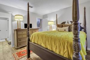 a bedroom with a bed and a dresser and two lamps at Ain't Nothin' Fancy in River Oaks