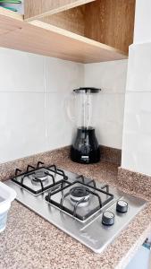 a stove top with a blender on a kitchen counter at Loft 60 Movistar arena 403 in Bogotá