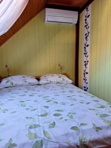 a bedroom with a large bed with a white bedspread at Apartment Bor in Bovec