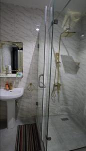 a bathroom with a shower and a sink at Iyoba Apartment in Abuja