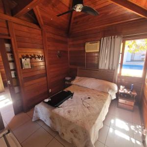 a bedroom with a bed and a ceiling fan at Cakau House - espaço amplo e aconchegante in Maricá