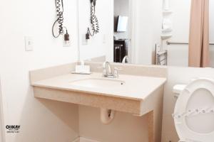 a bathroom with a sink and a mirror at Ohkay Hotel Casino in San Juan Pueblo +27 photos