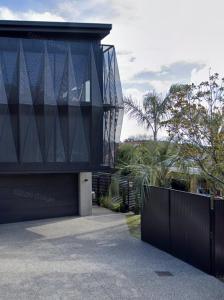a building with a black fence in front of it at CBD Grampians studio in Nelson