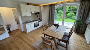 a kitchen and dining room with a table and chairs at Apartments FEICHTNER / Tulfes / Tirol in Tulfes