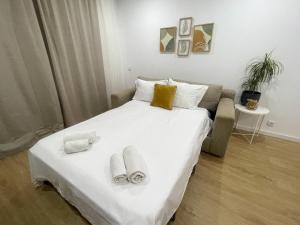a bedroom with a bed with two slippers on it at Solbelo Quarteira Beach in Quarteira +22 photos