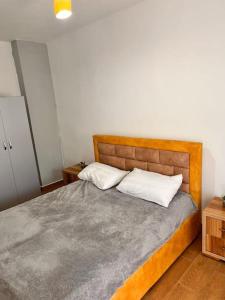 a bedroom with a bed with two pillows on it at Village House in Himare