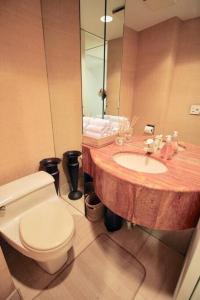 a bathroom with a toilet and a sink and a mirror at Private Beautiful Townhome w Zen Garden in New York