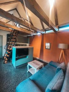 un soggiorno con divano, TV e scala a pioli di Kyritzer Budenhaus (Nr. 109) a Kyritz