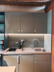 a kitchen with stainless steel cabinets and a sink at Kyritzer Budenhaus (Nr. 109) in Kyritz