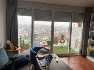 a living room with a large window with a view at Habitación luminosa en piso compartido in Mairena del Aljarafe