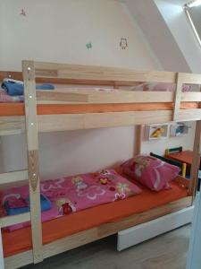 a bunk bedded room with two bunk beds at Ferienhaus Lilja mit Garten und Pool in Trzęsacz