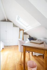 a room with a table and chairs in a attic at Cocon De confort proche de Paris in Créteil
