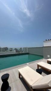 a view of a swimming pool on top of a building at Apartamento en Barranco in Lima