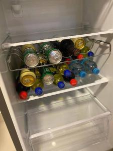 a refrigerator filled with lots of bottles of soda at Apartamento en Barranco in Lima