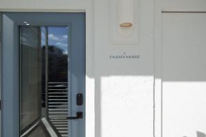 a door with a sign that reads terra novo at The Atlantic at The Tarrymore in Wrightsville Beach