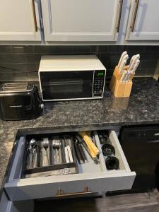 a kitchen counter with a drawer full of utensils at Rafeal in Houston