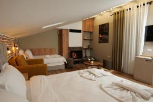 a hotel room with two beds and a fireplace at Vila Muslli in Korçë