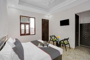 a hotel room with a bed and a table at The Royal Fern in Farrukhnagar